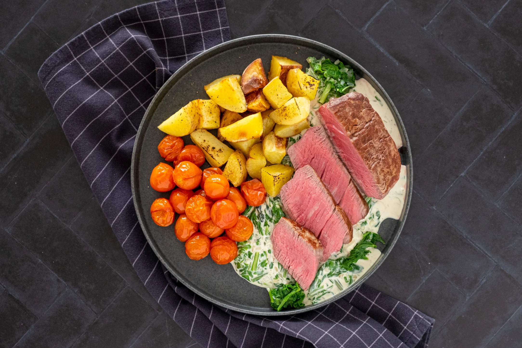 9 oz Fillet Steak with Creamed Spinach, Cherry Tomatoes and Roasted Potatoes