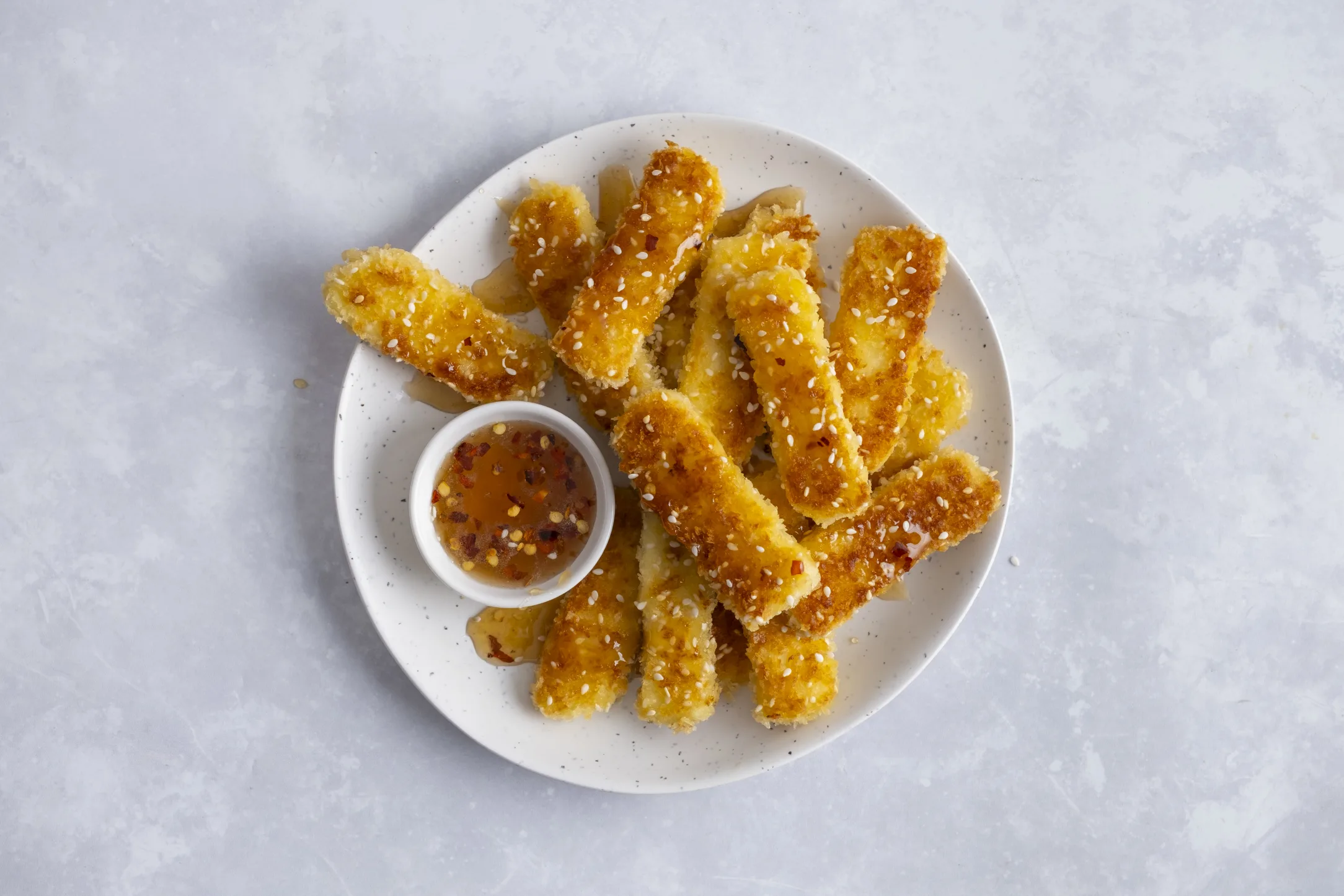Crispy Sesame Halloumi Fries with Hot Honey Drizzle