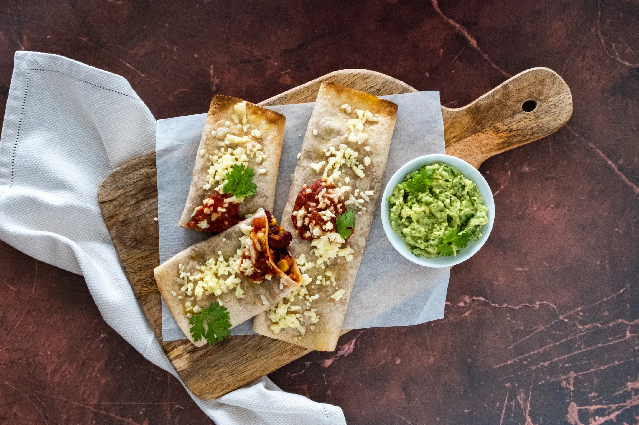 Spicy Bean and Corn Enchiladas with Vegan Mozzarella and Guacamole