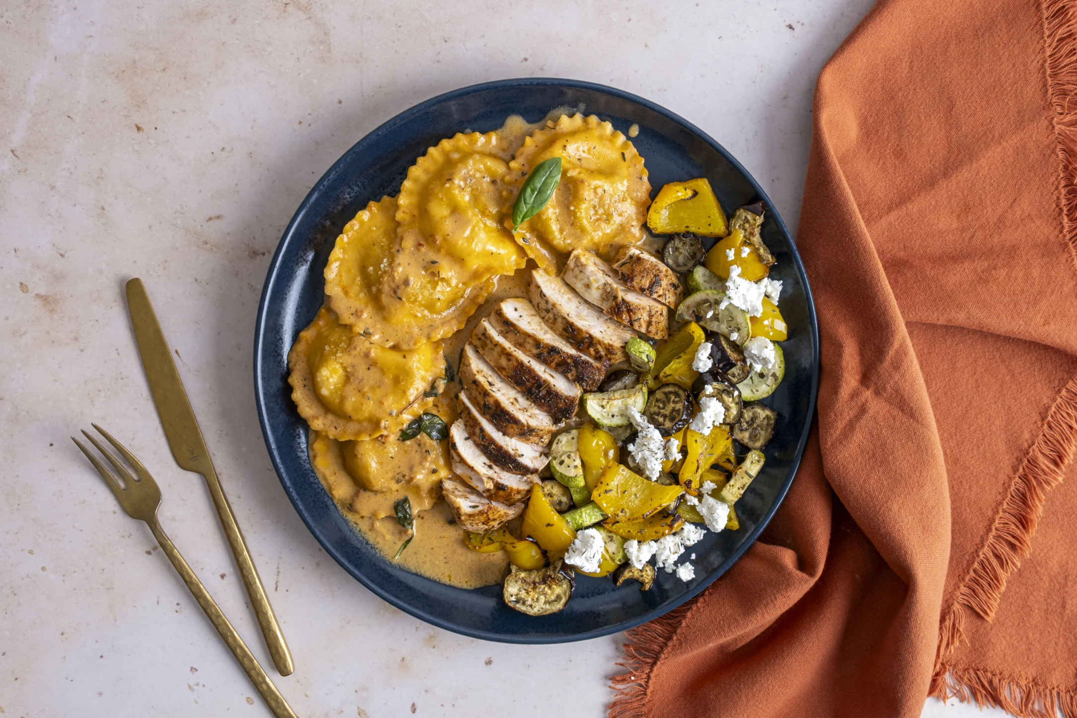 Chicken and Eggplant Parmesan Ravioli in Red Pesto Sauce with Roasted Veggies and Feta