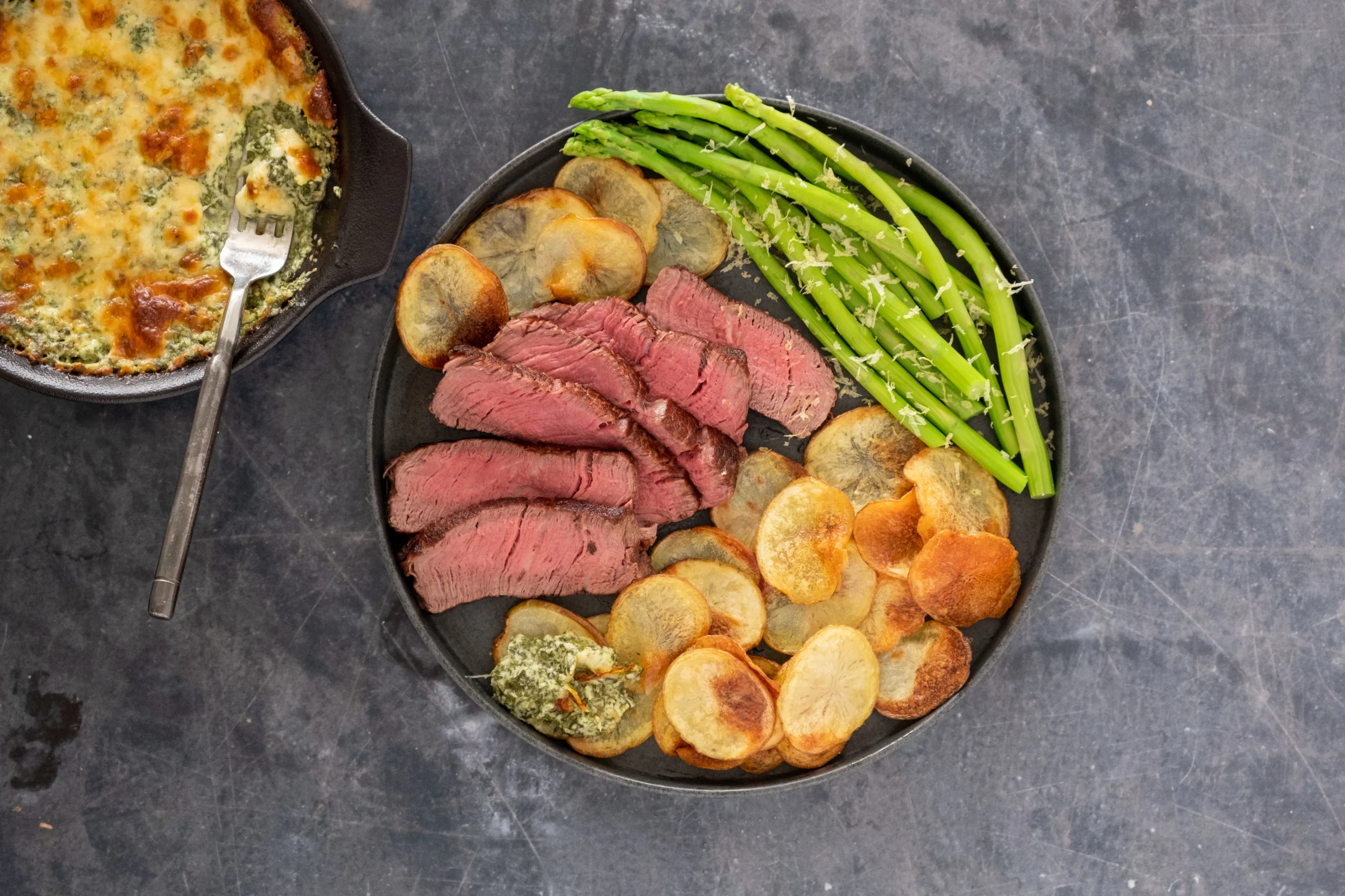 Tenderloin Fillet Steak and Cheesy Spinach Dip with Roasted Potato Discs and Asparagus