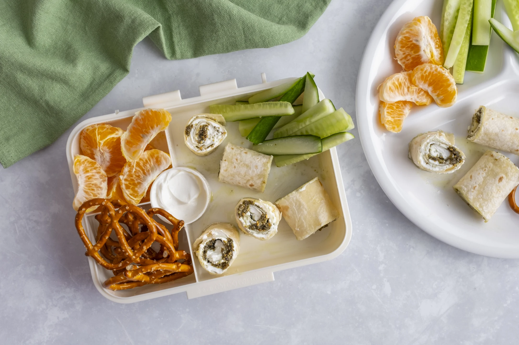 Labneh and Zaatar Tortilla Roll-Ups with Fresh Cucumber, Mandarins and Crispy Pretzels