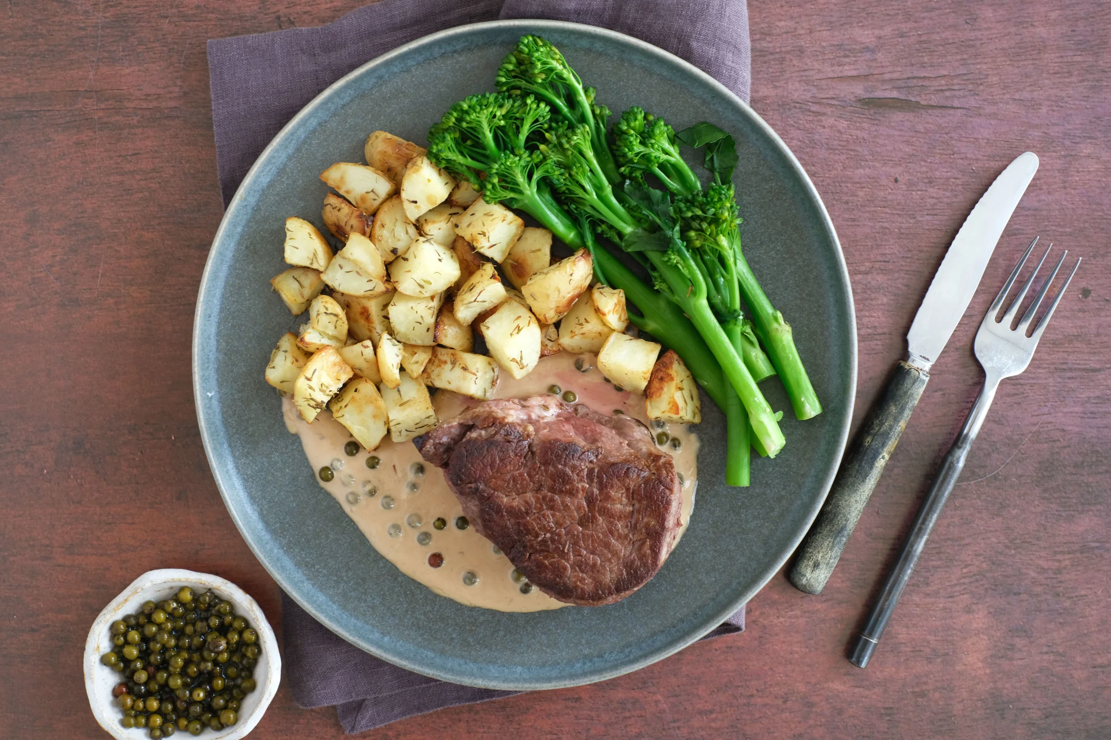 Tenderloin Fillet Steak with Broccolini, Roasted New Potatoes and Green Peppercorn Sauce