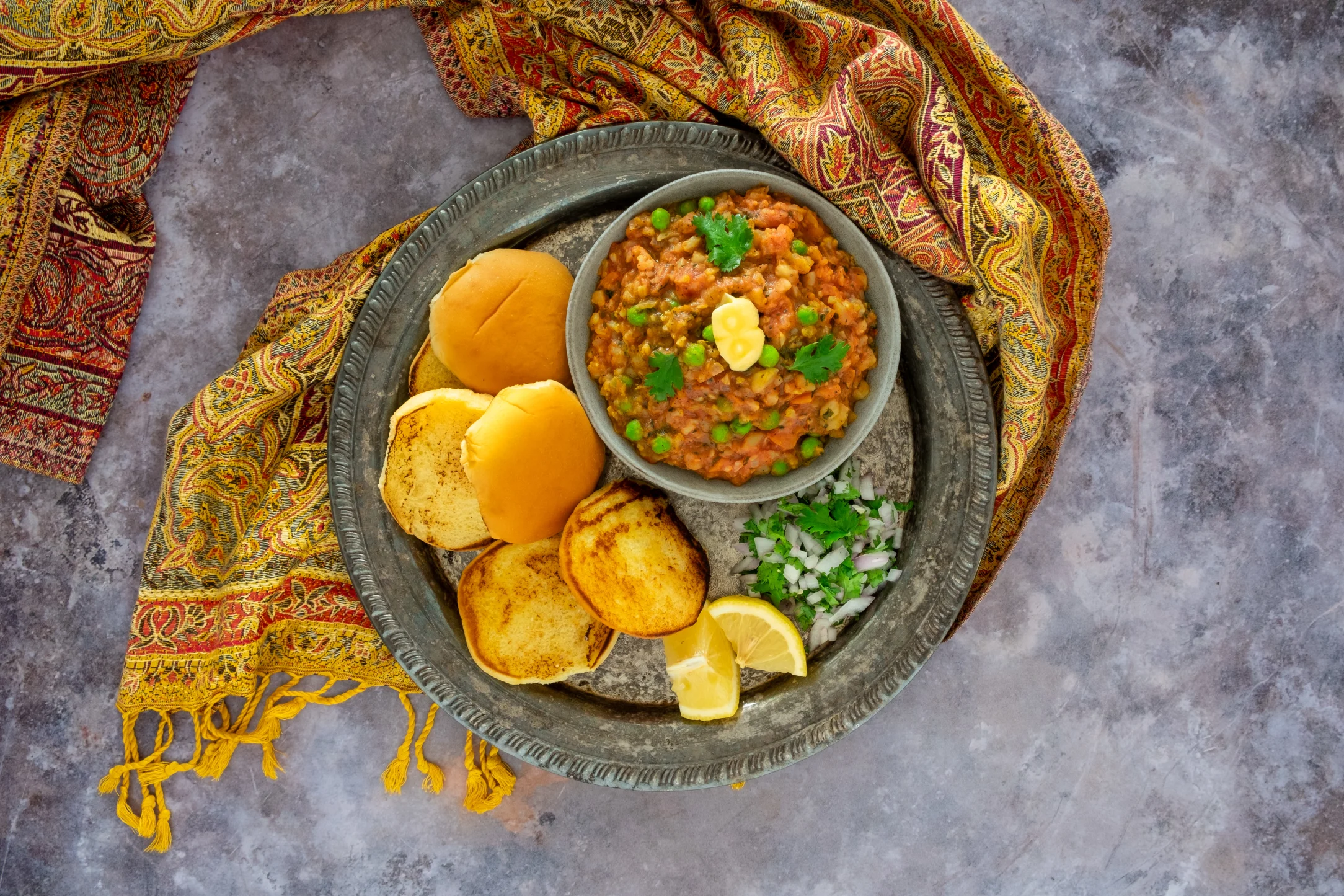 Pav Bhaji: Indian-Spiced Vegetable Curry with Toasted Buns and Onion Salad