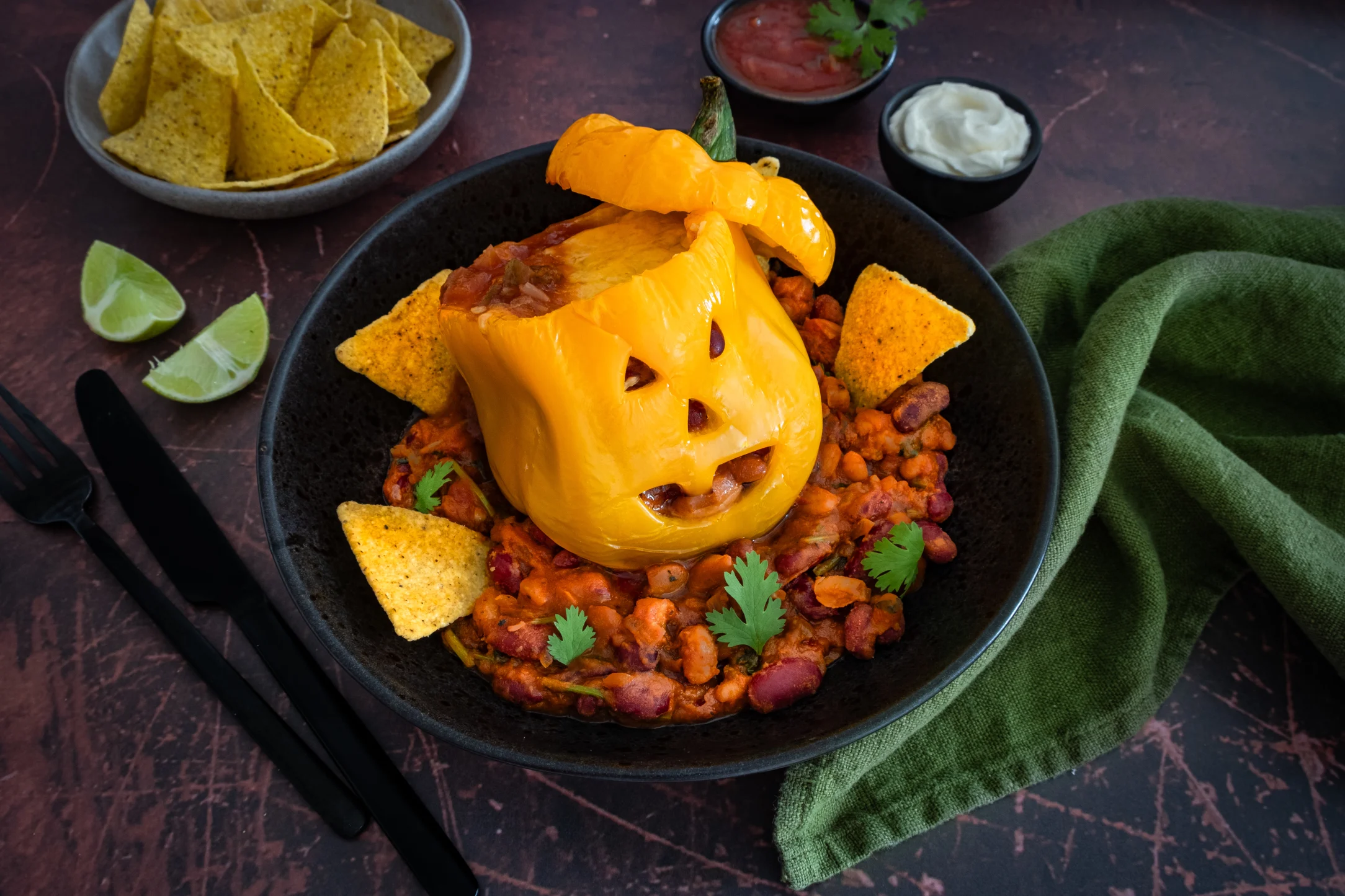 Spooky Peppers: Bean Chilli Stuffed Peppers with Tortilla Chips, Salsa and Sour Cream