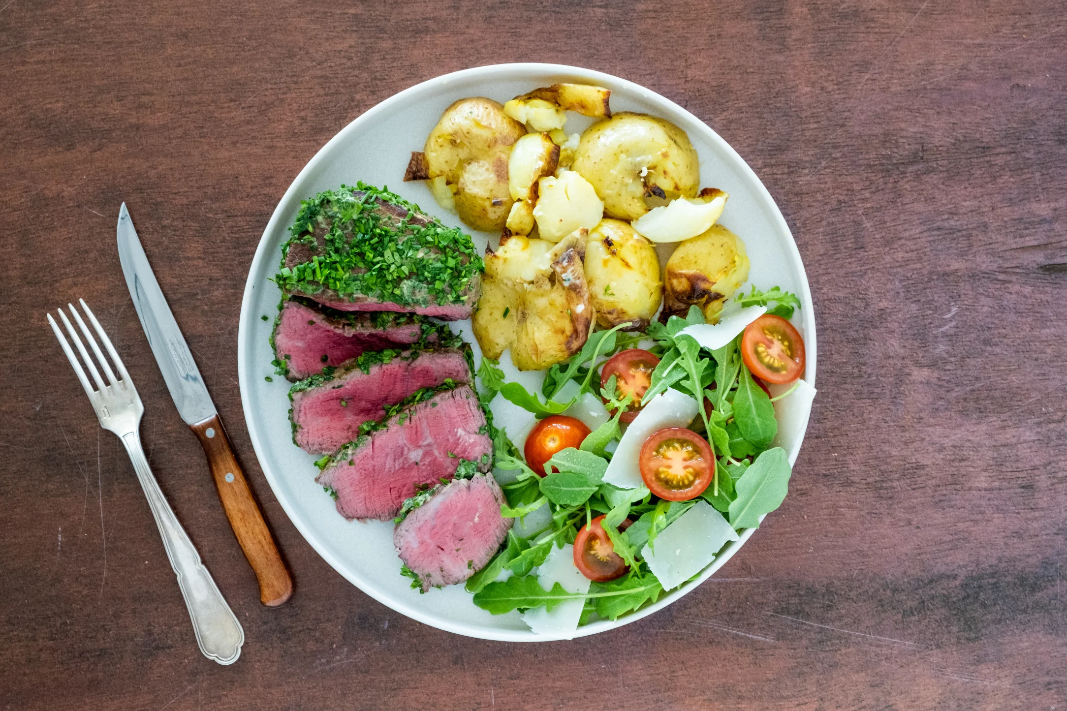 Herb Crusted Fillet Steak with Crushed Potatoes and Rocket Salad