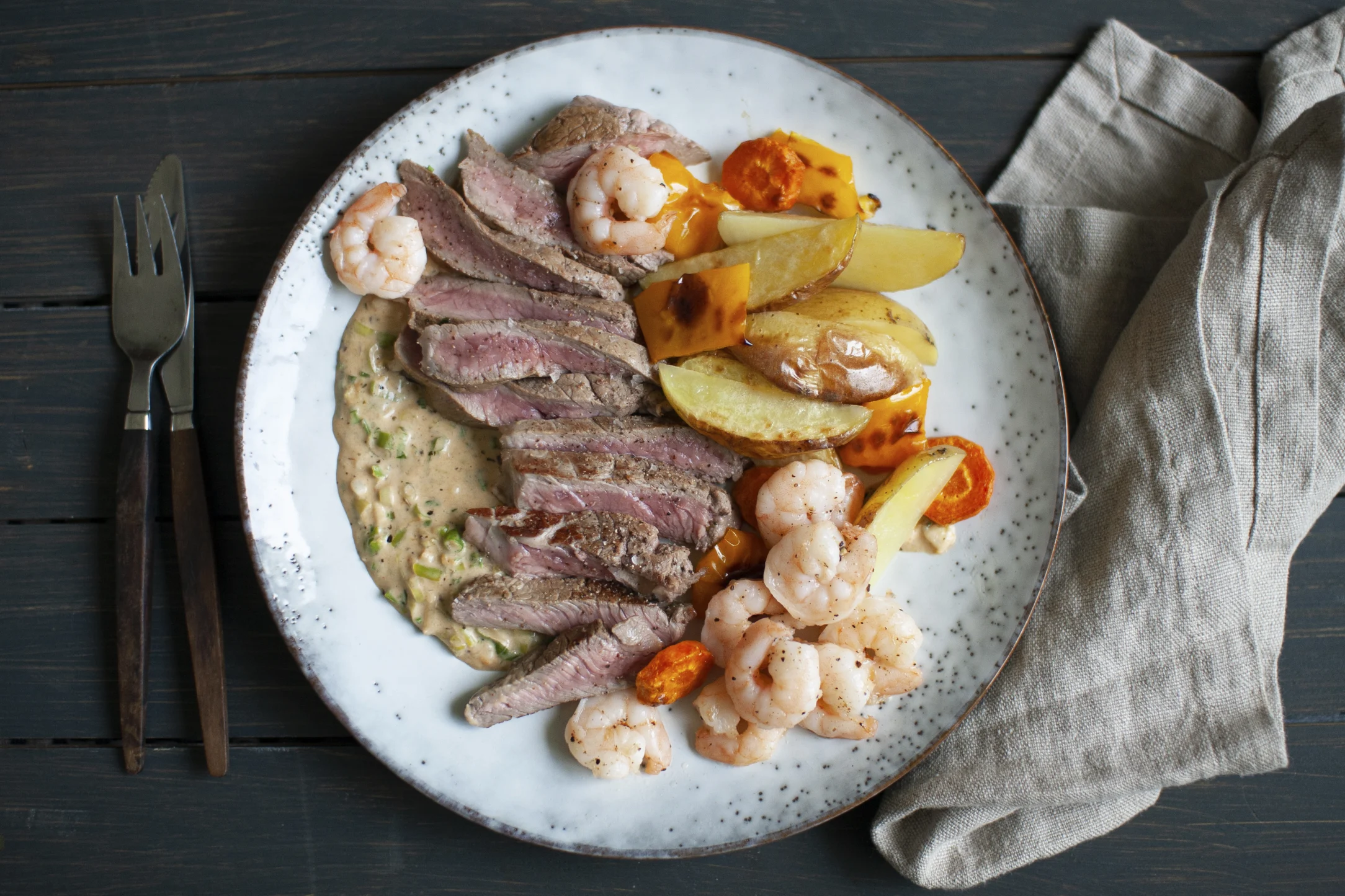 Cajun Steak and Prawn Surf and Turf with Cream Sauce, Roasted Potatoes and Vegetables