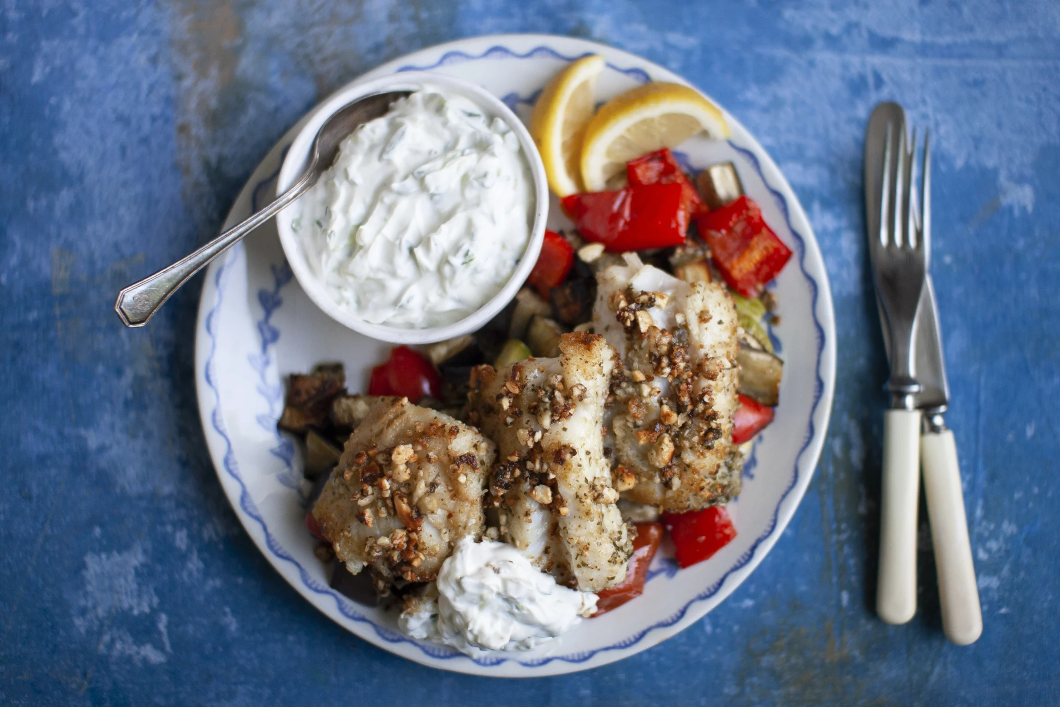 Cashew Crusted Pesto Cod with Mediterranean Vegetables and Tzatziki