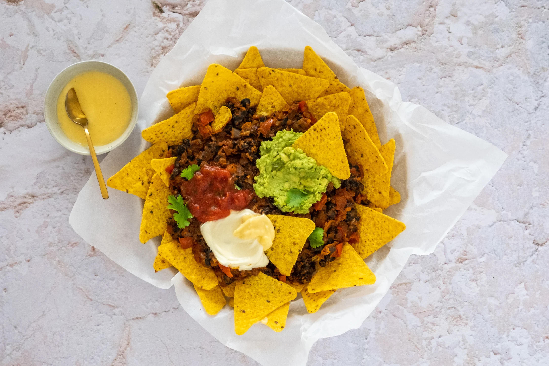 Loaded Nachos with Beans, Guacamole, Sour Cream and Homemade Cheddar Cheese Sauce
