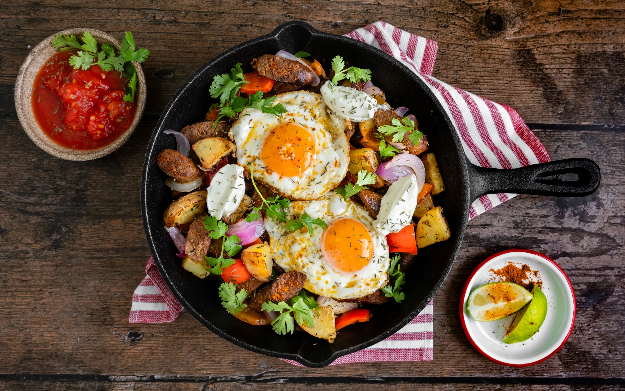 Southwest Sausage and Potato Hash Skillet with Fried Eggs, Salsa, and Sour Cream