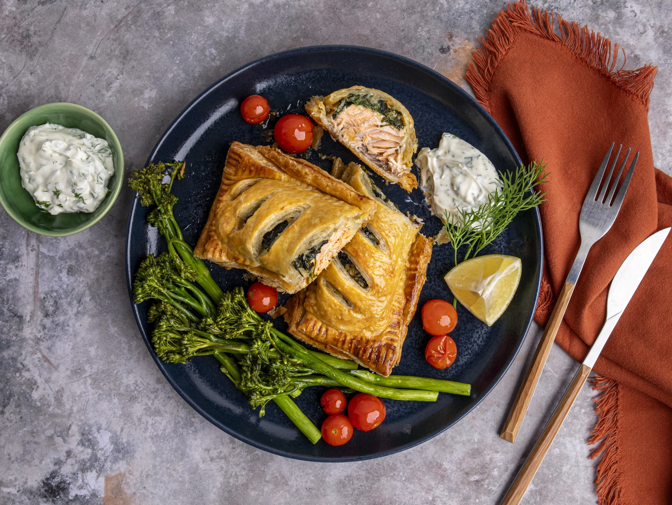 Salmon En Croute Puff Pastry with Creamed Spinach, Roasted Vegetables, and Dill Cream Sauce