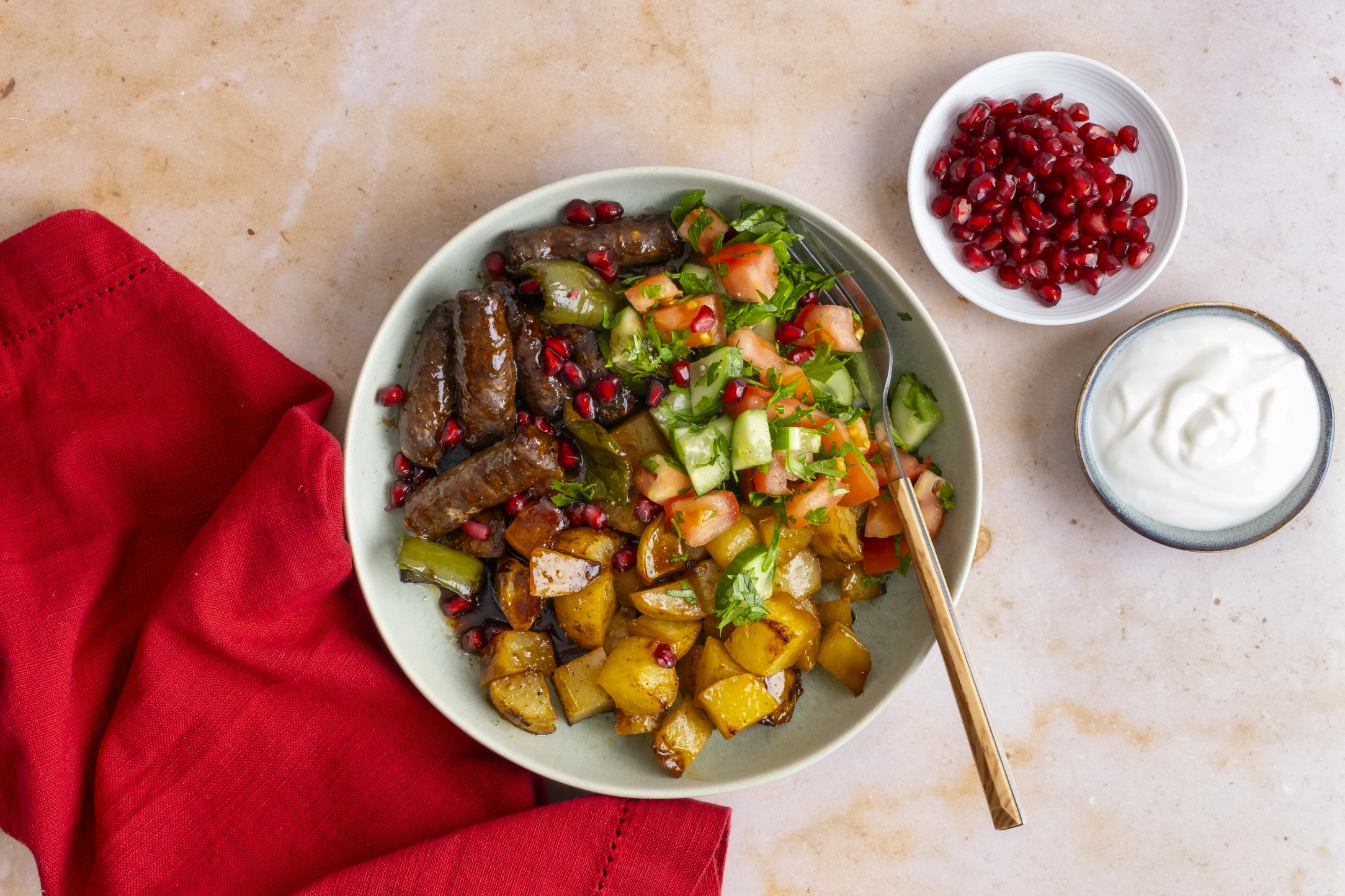 Spicy Merguez Beef Sausage with Roast Potatoes, Pomegranate Dressing and Fresh Salad