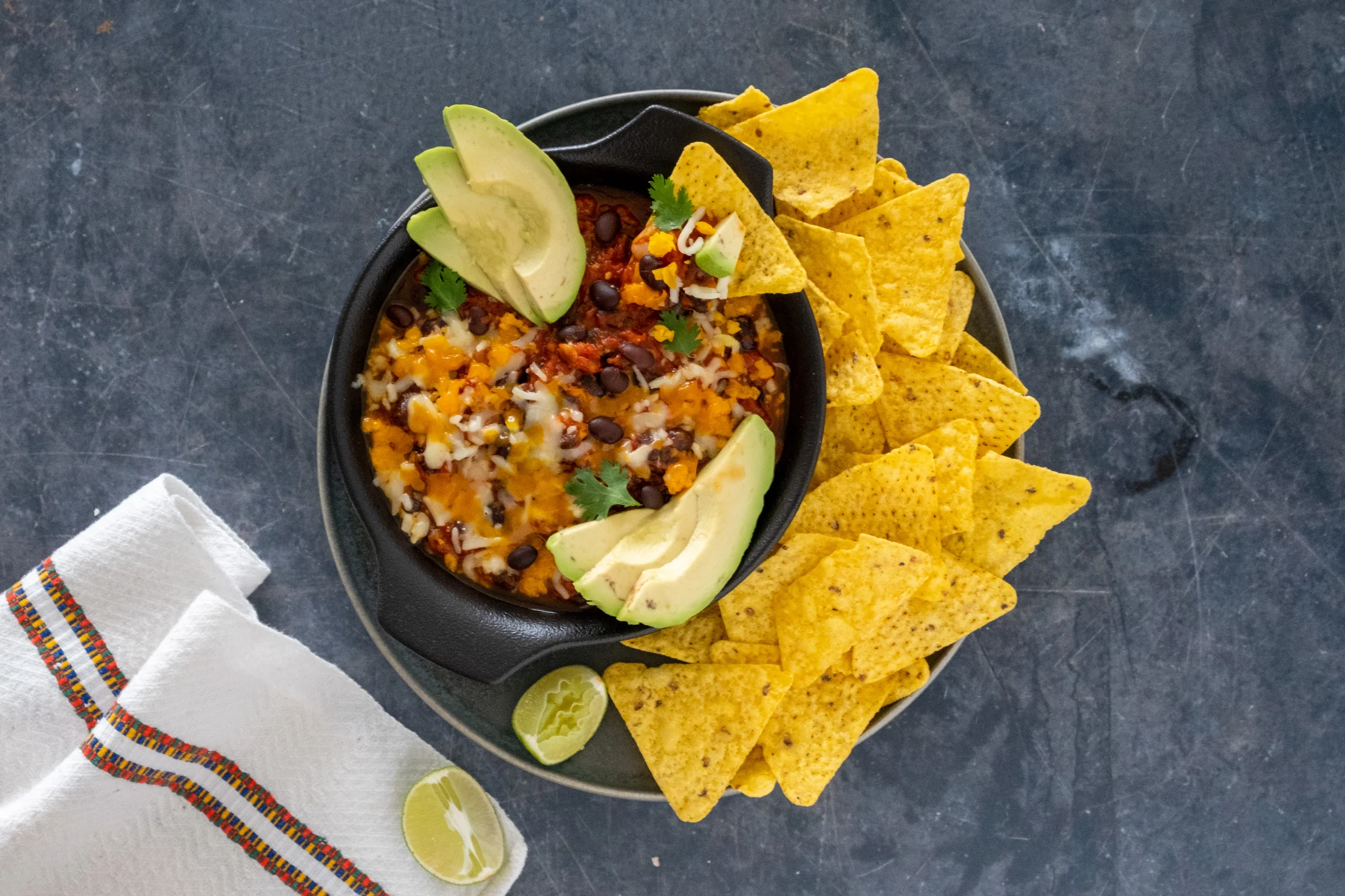 Hot and Cheesy Black Bean Nacho Dip with Avocado