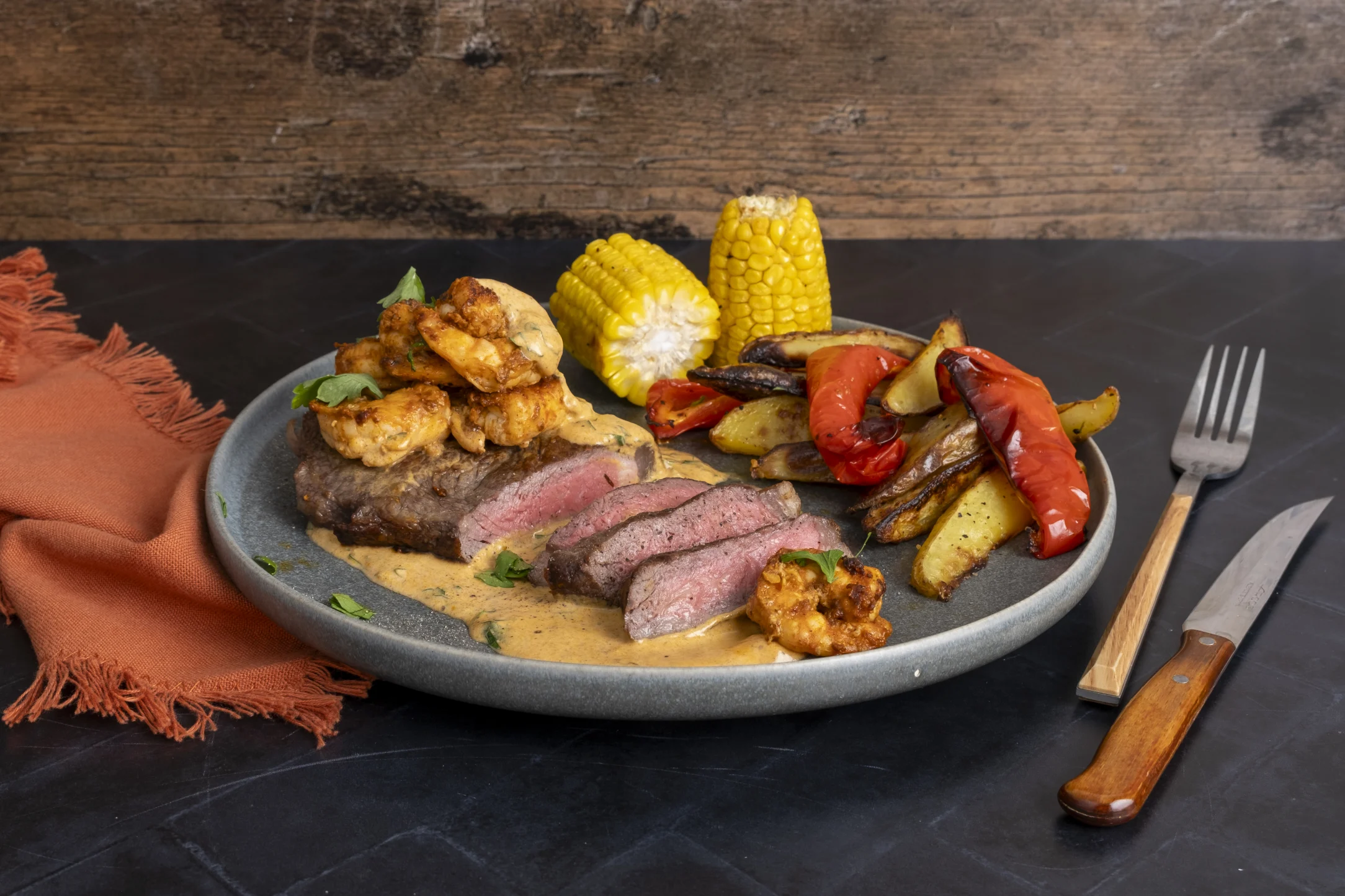 Surf 'n' Turf: Sirloin Steak and Prawns with Cajun Cream Sauce and Roasted Vegetables