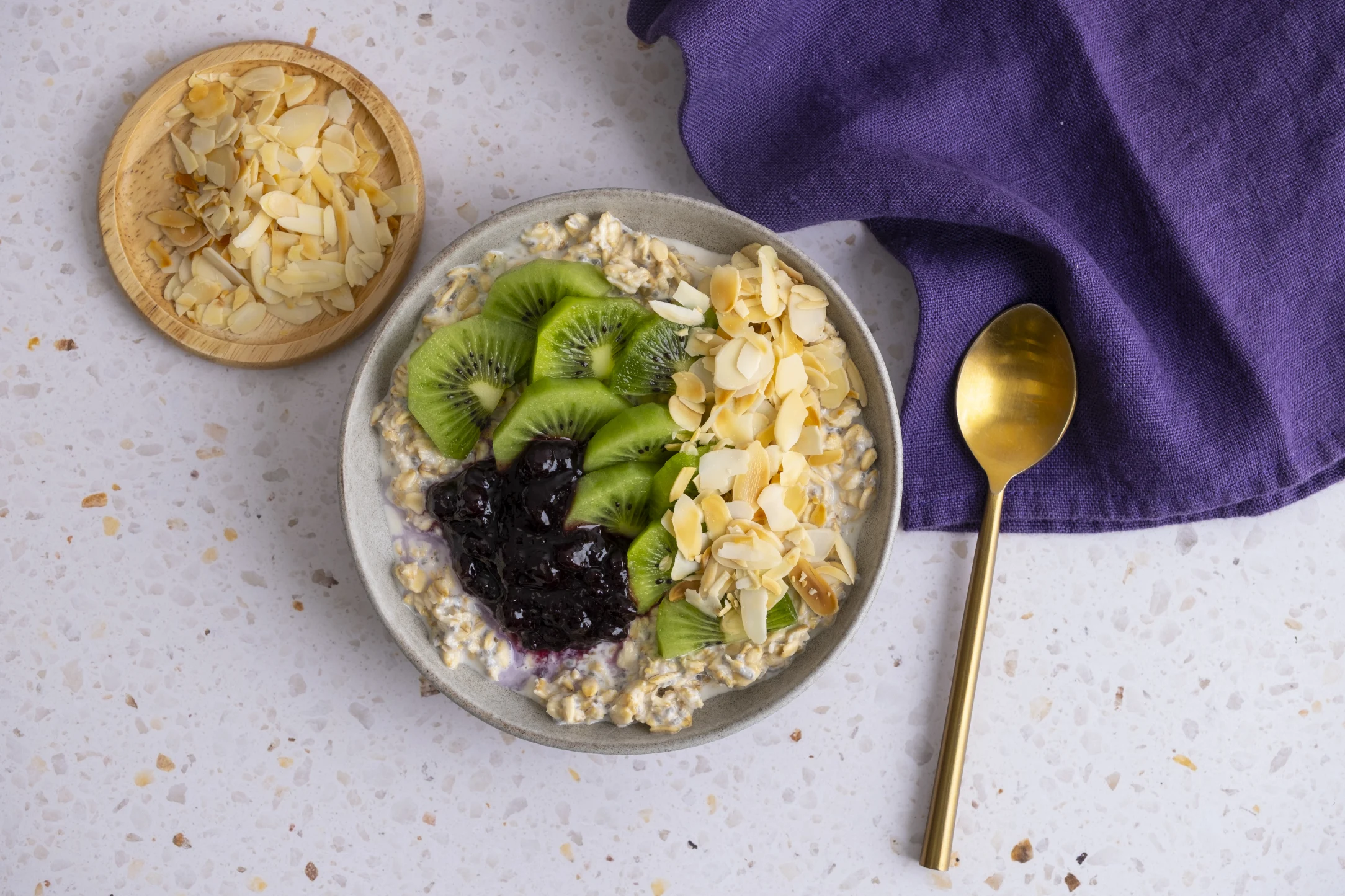 Overnight Oats with Fresh Kiwi, Blueberry Jam and Flaked Almonds