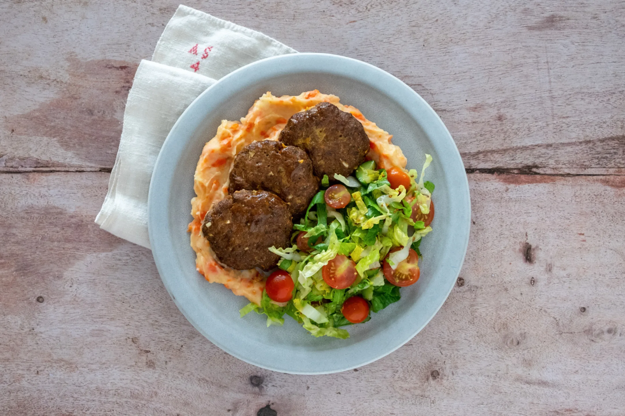 Oven Baked Beef Patties with Creamy Potato and Carrot Mash and Green Salad