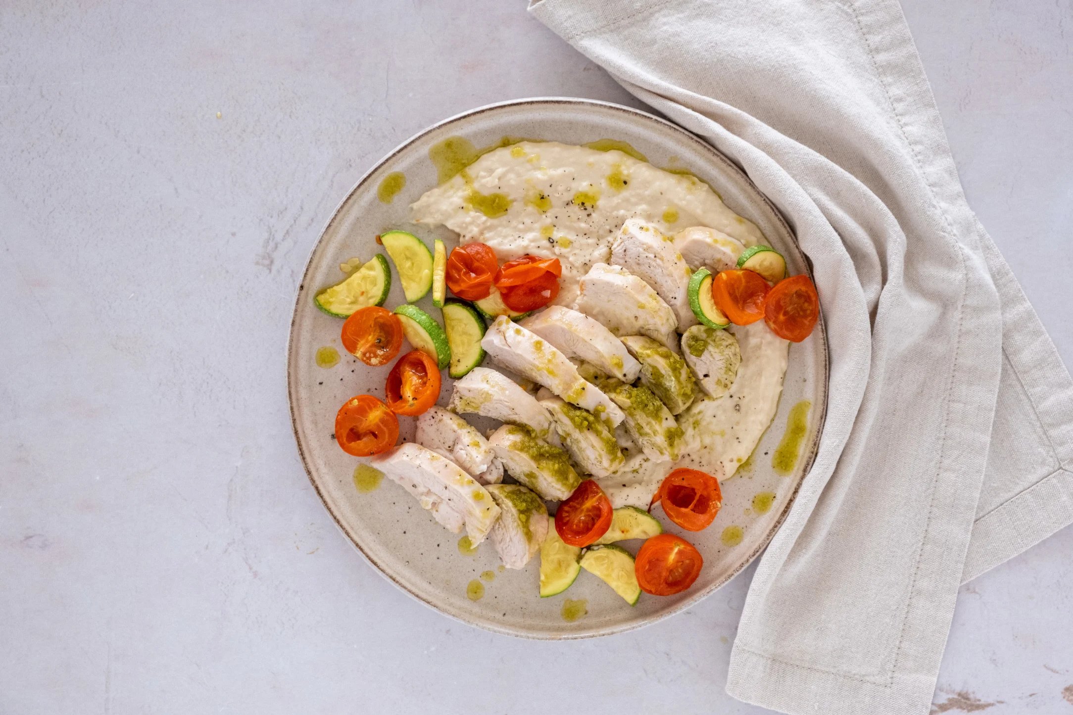 Pesto Baked Chicken with White Bean Puree, Roasted Tomatoes and Zucchini