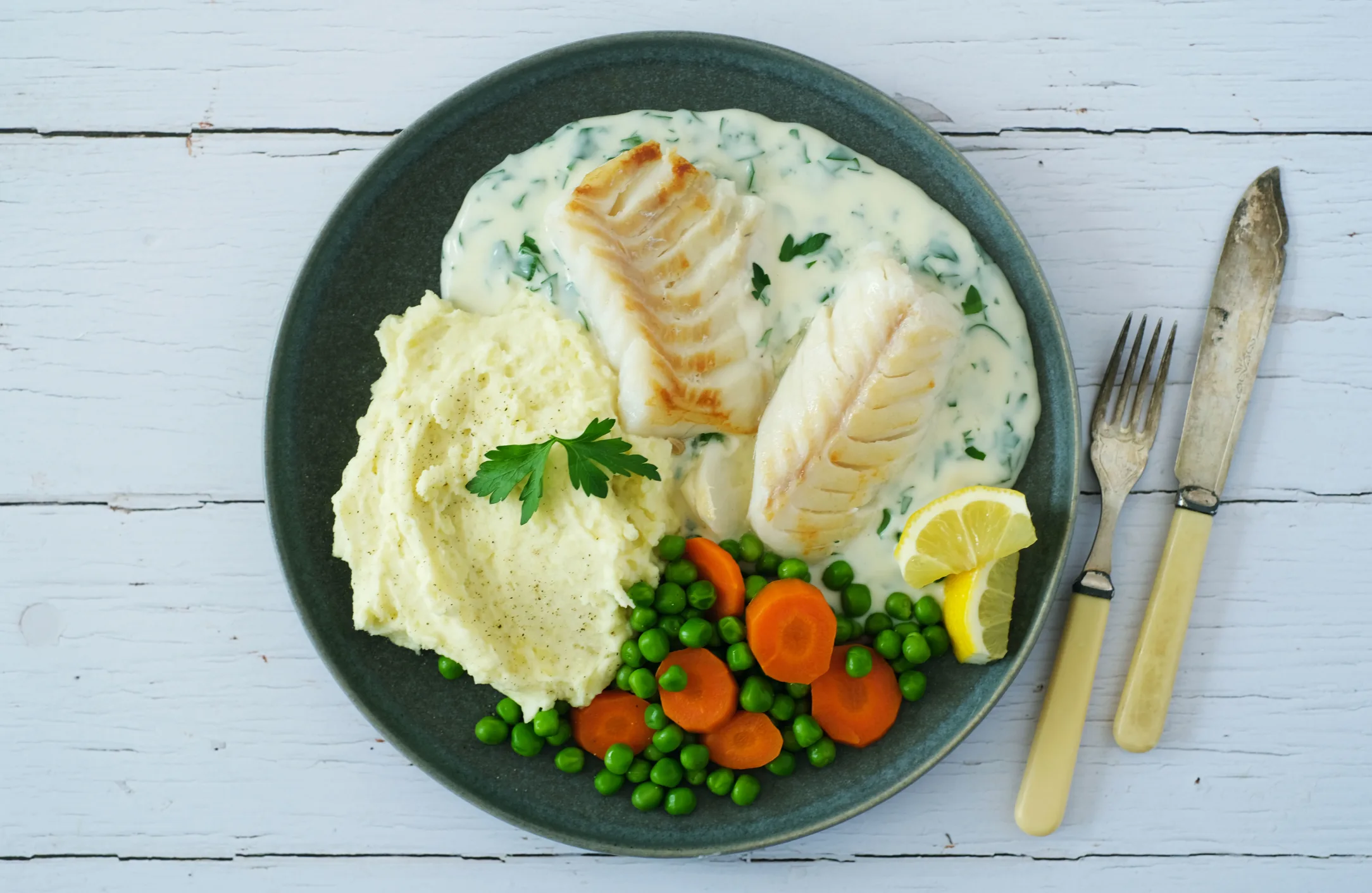 Cod in Parsley Sauce with Mashed Potato, Carrots and Peas