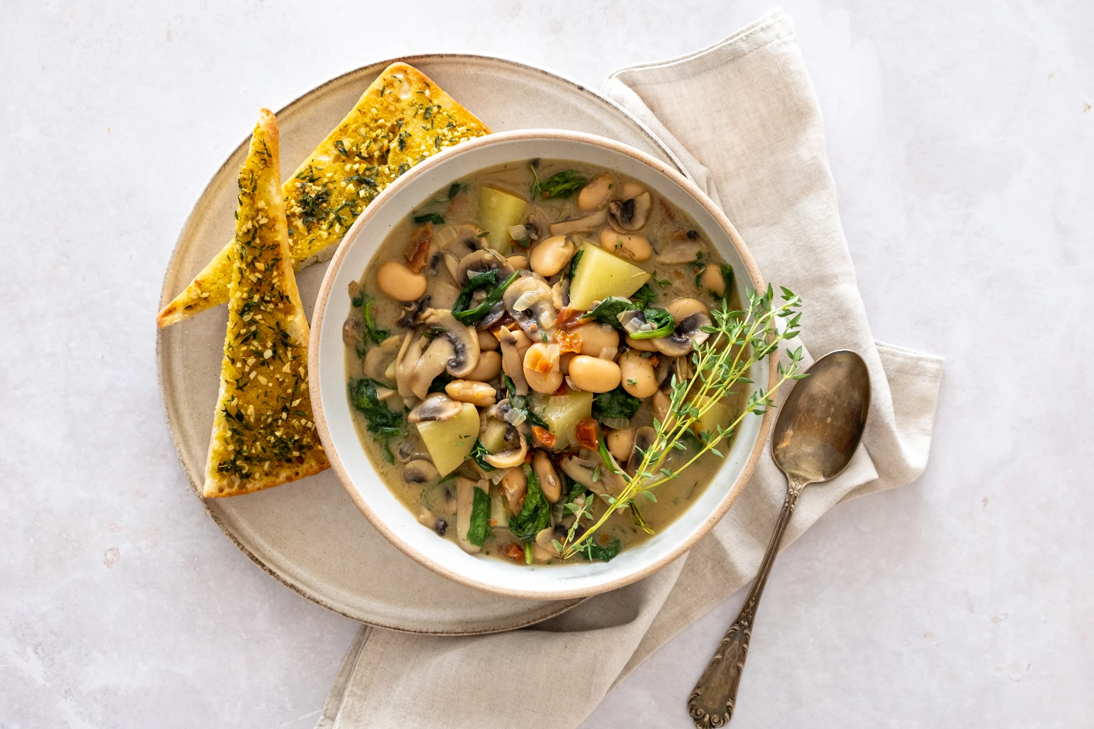 Creamy White Bean, Potato, and Mushroom Stew with Sun-dried Tomatoes and Garlic Thyme Ciabatta