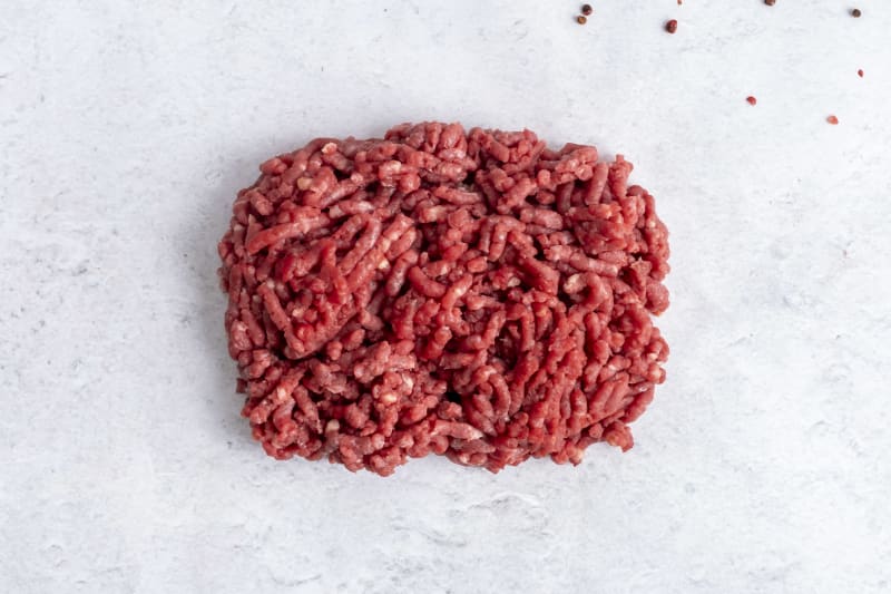 Grass fed beef mince, raw, on light marble