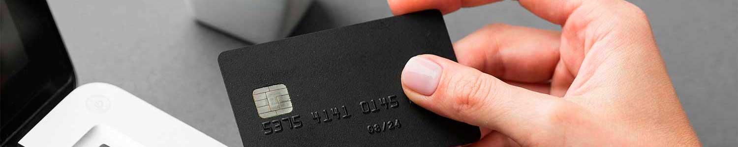 Persona sosteniendo una tarjeta de crédito negra