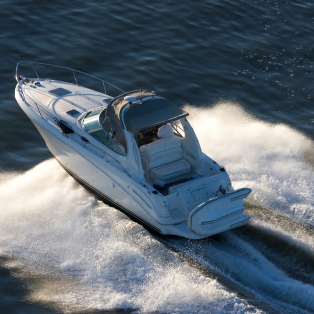A jet boat speeding across a body of water.