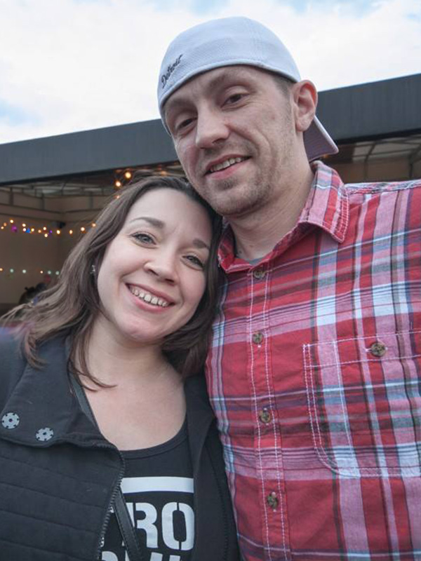 Jasen & Becky Wyatt smiling on a patio.