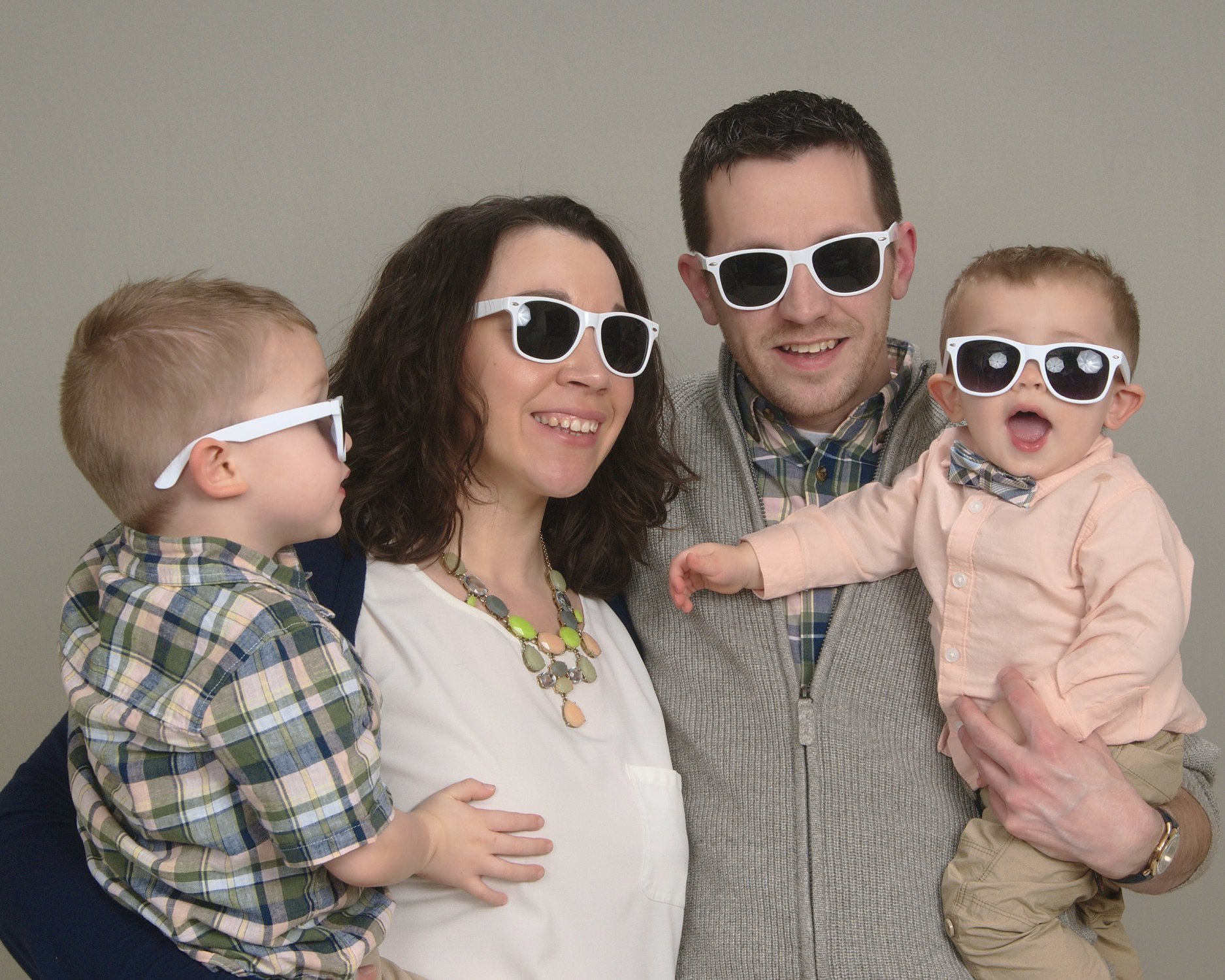 The Wyatt's smiling wearing sunglasses.