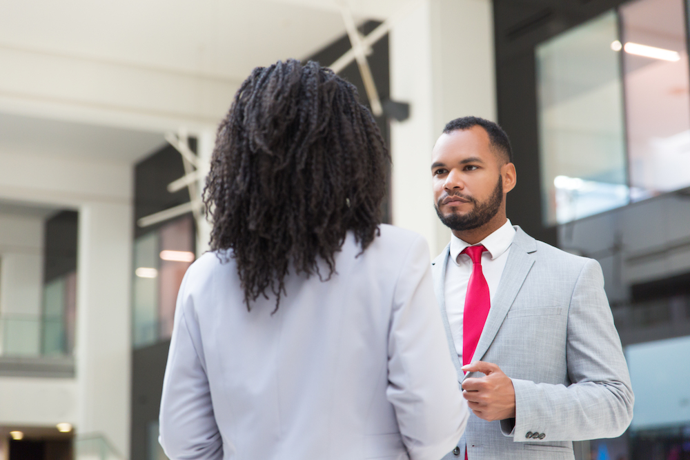 A female staff talking to male staff about accountability