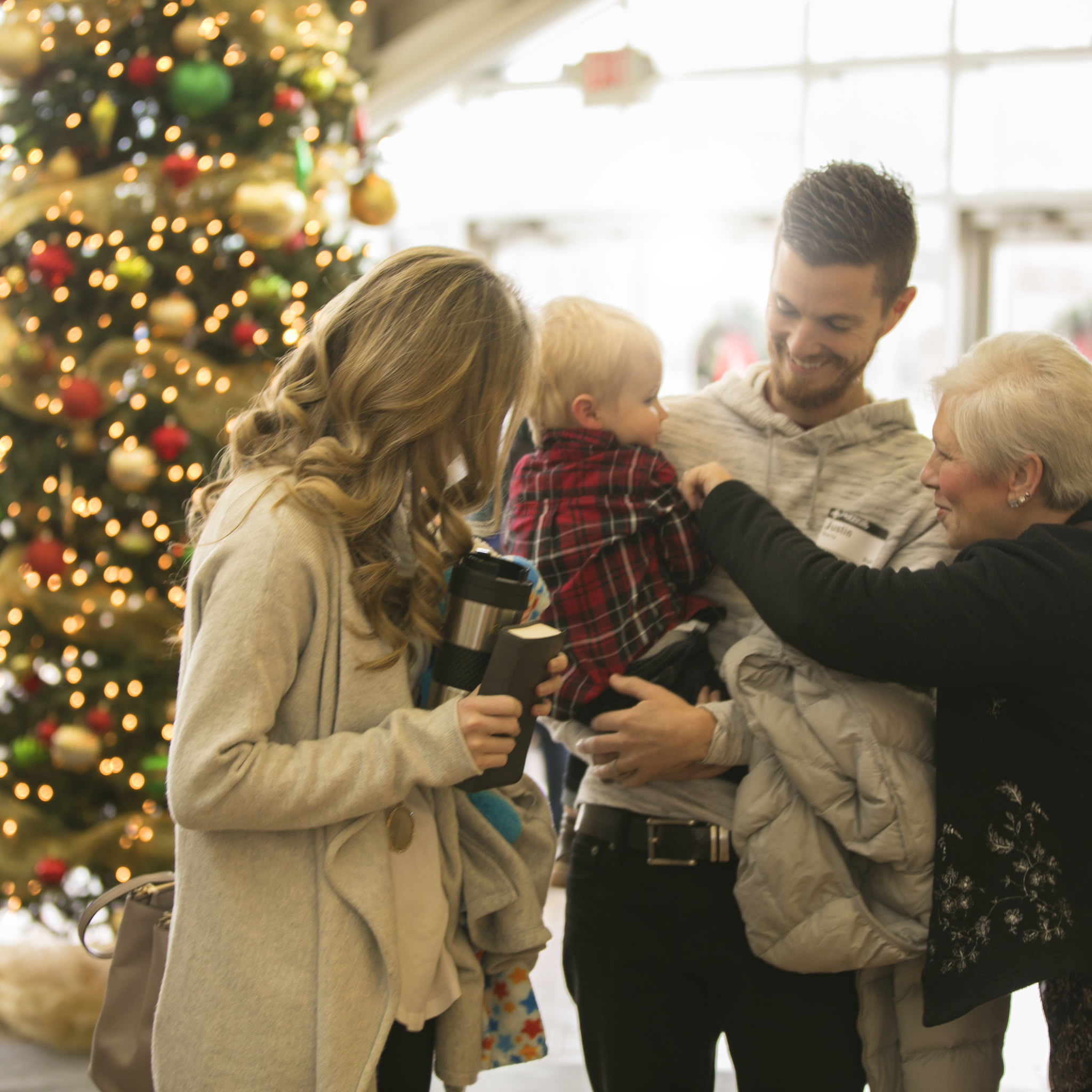 Young Family At Christmas Service