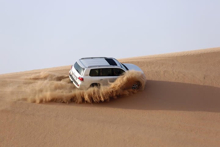 Evening Desert Safari With BBQ Dinner, Camel Ride and Sand Boarding image