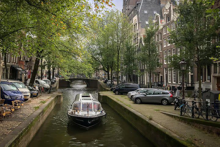 Audio guided tour on a covered boat through the canals of Amsterdam image