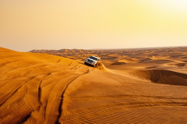 Dubai desert safari with evening barbecue & buffet, camel ride and sandboarding image