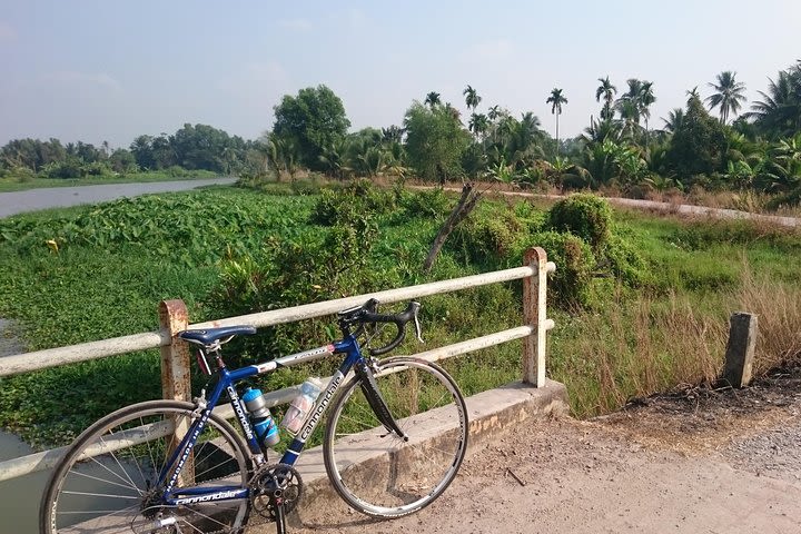 Cycling to CuChi tunnels - single track ride along Saigon river.  image