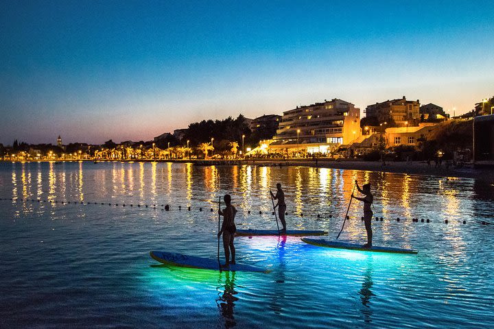 Glowing Stand-Up Paddle Experience in Split image