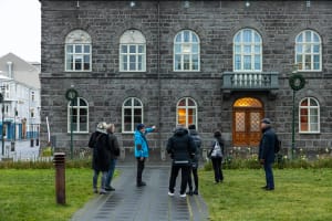 Travellers listening to the Guide from Your Friend in Reykjavik in front of the parliament building in downtown Reykjavik 
