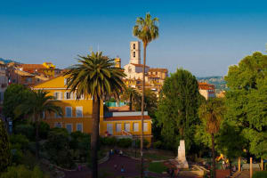 Palm trees and gardens overlooking the historic centre of Grasse on the French Riviera.