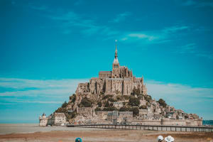 Pedestrian bridge and shuttle buses approaching Mont Saint Michel