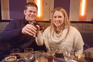 A couple enjoying a glass of snaps after sampling beers