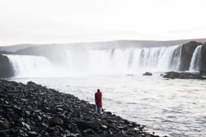 Waterfall with surrounding cliffs and rugged terrain