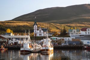 Harbor view of Húsavík town with boats docked