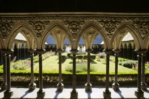 Gothic cloister of Mont Saint Michel abbey with stone arches and garden