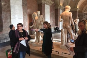 Visitors viewing sculptures inside the Louvre Museum