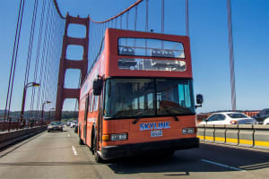 Red double-decker Skyline tour bus crossing the Golden Gate Bridge in San Francisco