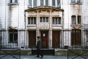 Ornate stone doorway and windows on a historic building in Le Marais