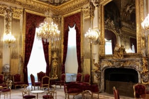Gilded historic room and chandeliers inside the Louvre Museum