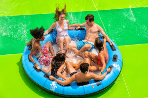 6 rides in a raft tube on a green waterpark side at Island H2O