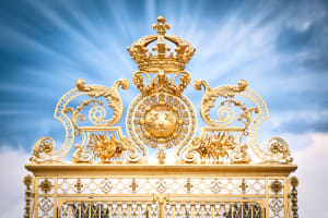 Ornate golden gate at the Palace of Versailles