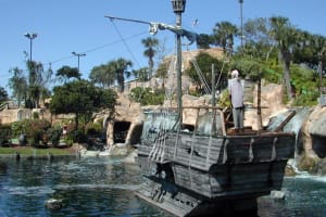 A wooden pirate ship in a pond at mini golf pirates cove orlando