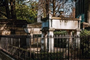 Stone tomb marked Molière behind a protective railing